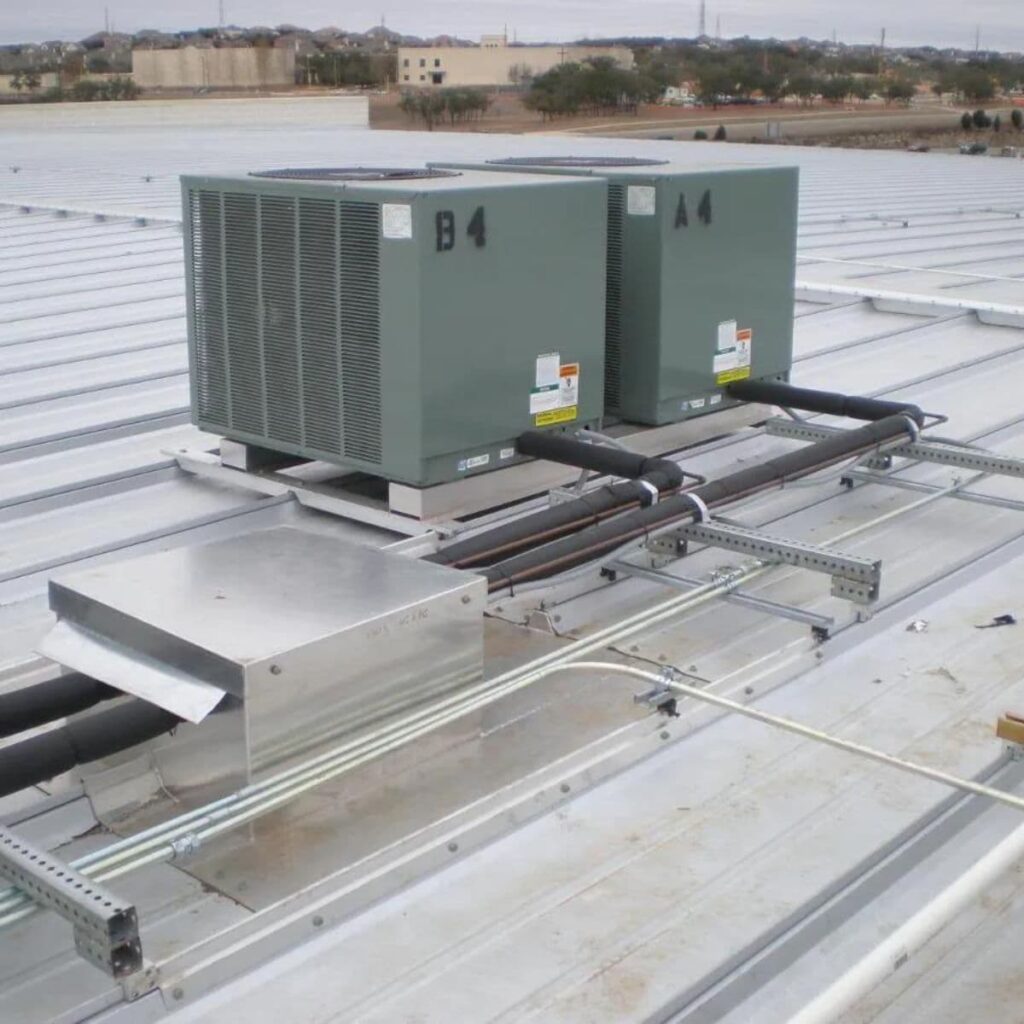 two commercial heating and cooling units on the top of a business