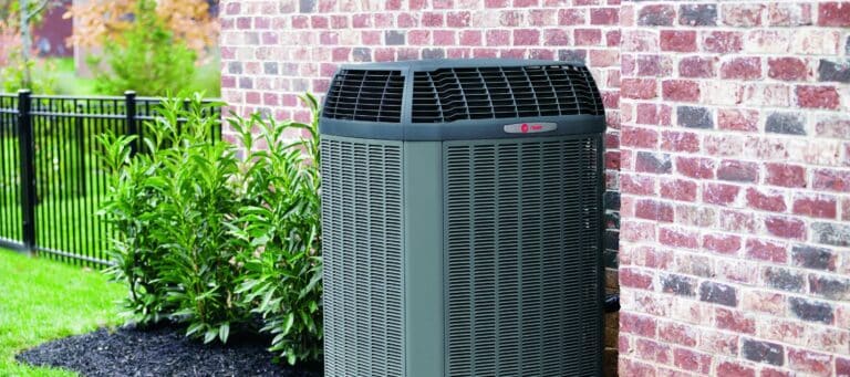 an outdoor trane ac unit installed next to a San Antonio home