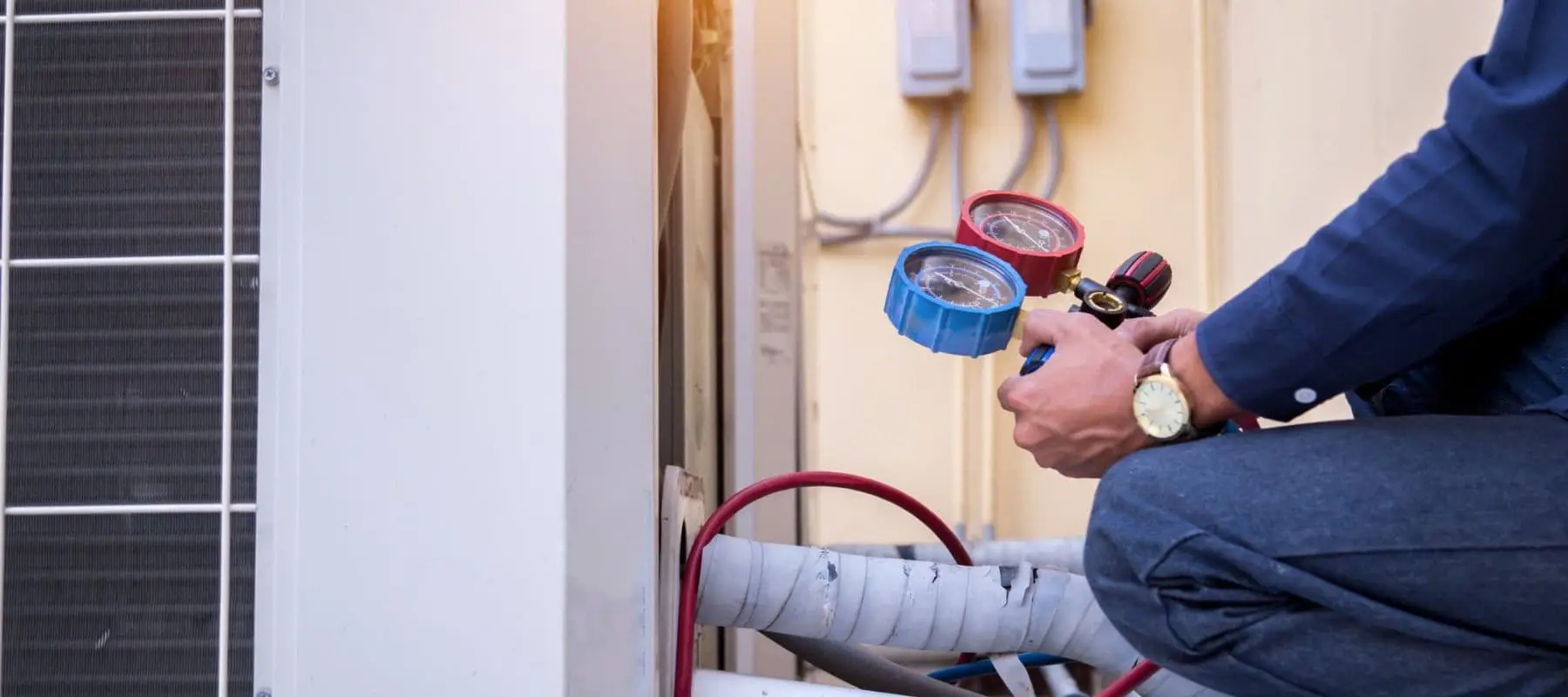 Technician checking HVAC pressure gauges.