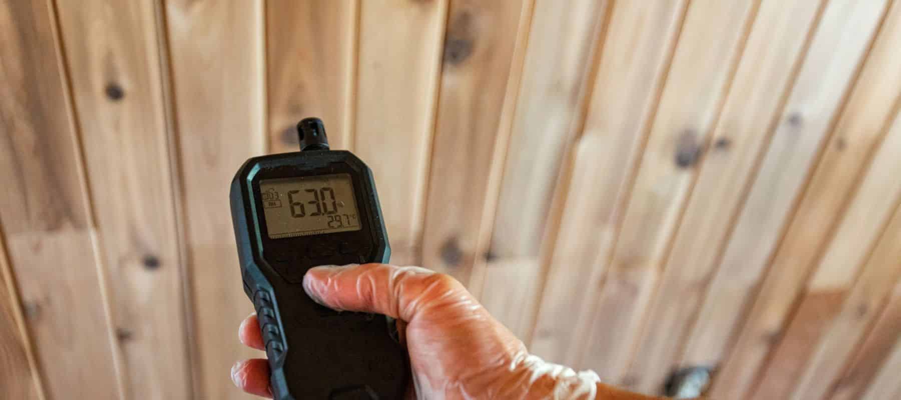 closeup of a technician hand holding an indoor air quality testing tool