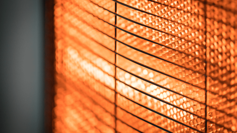 A close up photo of a space heater turned on.