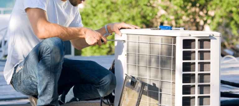 technician performing repairs on a heat pump system