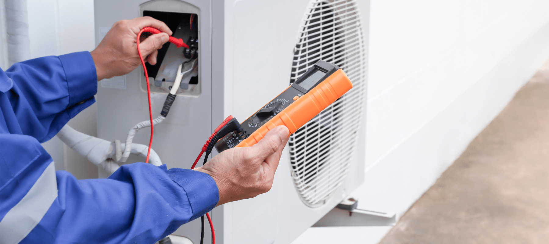 technician using a pressure reading system on a heat pump