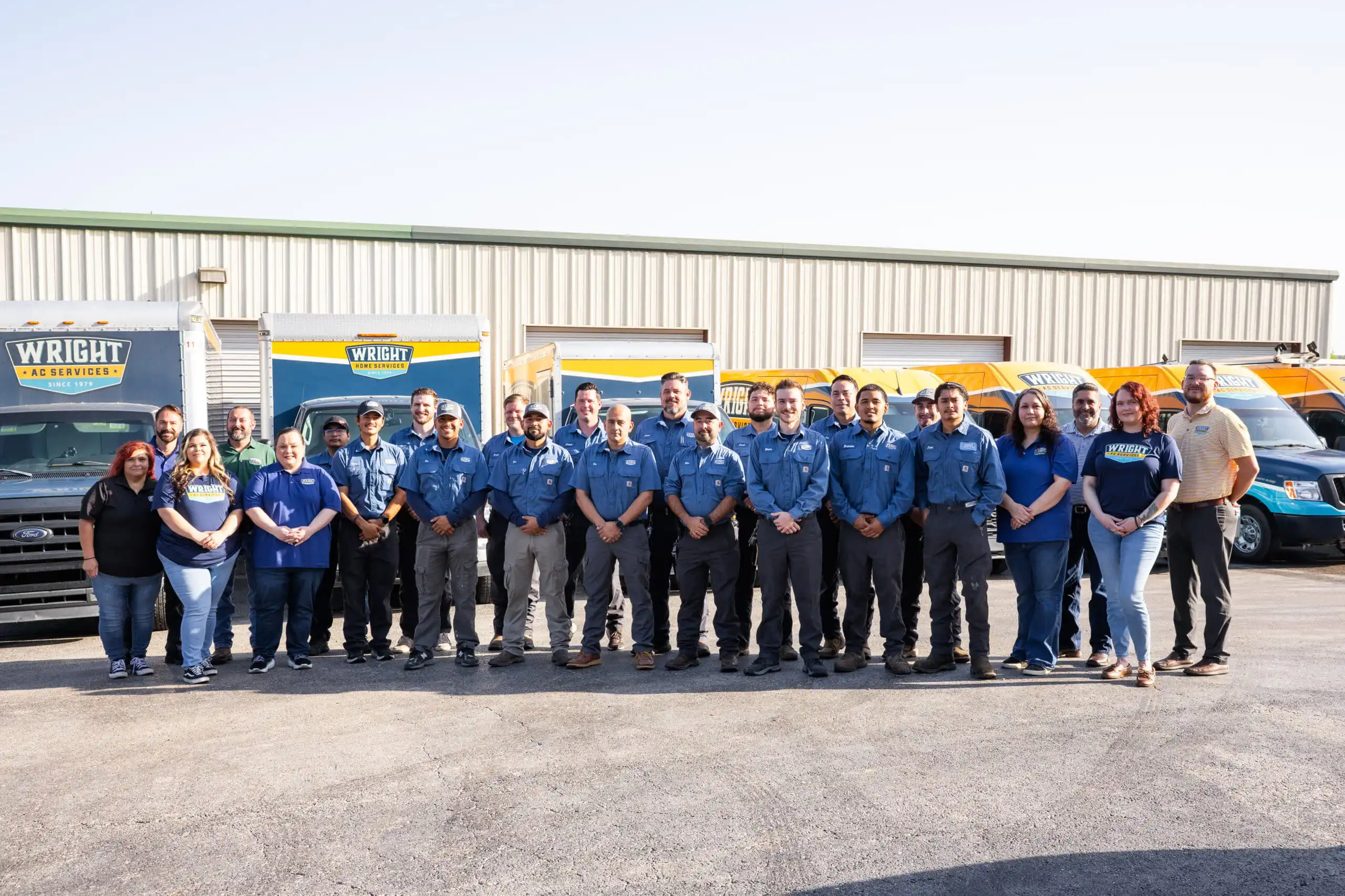 Group of uniformed workers posing together.