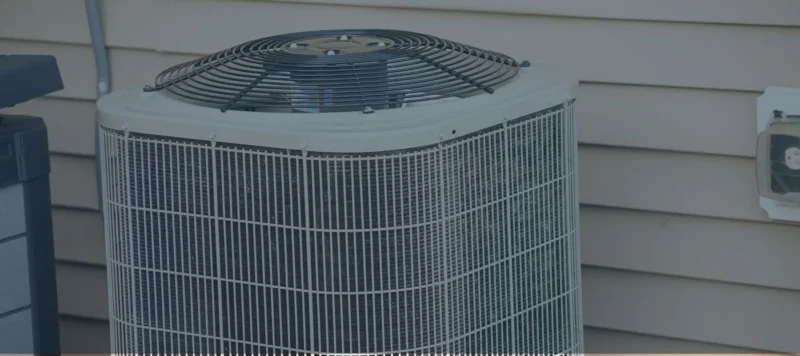 Close-up of a newer outdoor AC unit with a clean metal grille