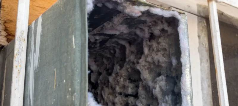 old air duct filled with dust and dirt